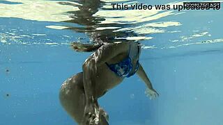 Irina Cage, half Russian-Spanish, swims nude underwater in cage