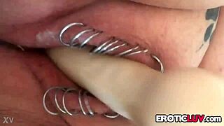 This horny babe works her pierced pussy with toys.