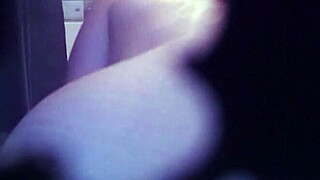 I watch this tattooed babe rip her clothes off while stripping in the shower, her body glistening under the water as she teases me with every move