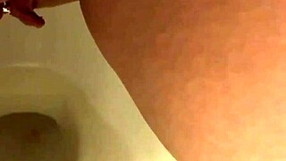 my pretty pierced brunette pees in bathroom