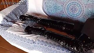 Petite amateur in total black lingerie fishnets pantyhose and over-the-knee boots shows ass