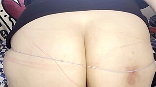 A curvy woman snaps rubber bands on her big ass in bdsm