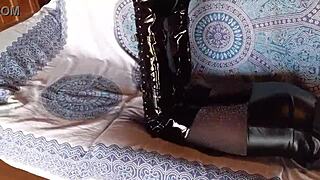 Petite amateur in total black lingerie fishnets pantyhose and over-the-knee boots shows ass