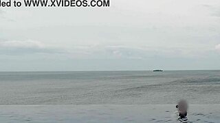 skinny student with cute legs relaxes by the infinity pool