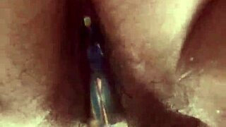 Solo hairy beaver glass dildo close up.