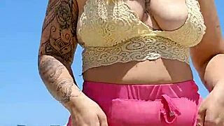 african woman flashes big pussy lips to excite her beach lover