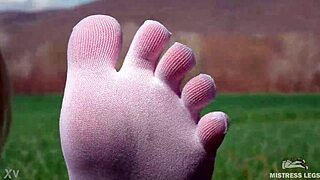 Goddess Feet In Cute White Socks With Jeans On The Spring Grass Field