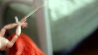 batgirl doll from dc comics is tied up and gets showered in sticky substance