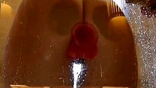 Girl with appetizing ass plays in shower using pink toy for fun.