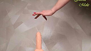 hot milf slips into sexy red fishnets, grabs a big dildo, yet teases slowly before riding it deep for juicy orgasm.