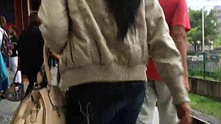 In the crowded train setting, a woman sports a casual jacket and sturdy boots during her daily commute. Part 1.