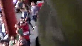 In the crowded train setting, a woman sports a casual jacket and sturdy boots during her daily commute. Part 1.