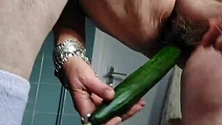 Grandma stuffs her hairy beaver with a big cucumber in wild German solo action.