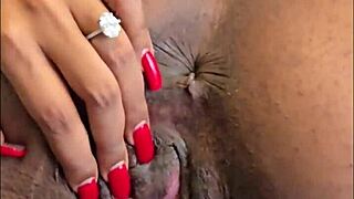 This hot ebony slut bends over to finger her shaved pussy and pierced clit.