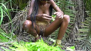 hot african native woman cooks in jungle kitchen with nature around her skinny frame