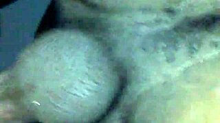 A diverse couple explores intimate connections in a shared moment.