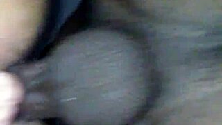 A diverse couple explores intimate connections in a shared moment.