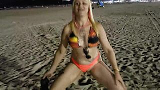 Blonde beach babe flashes tits and pussy in public voyeur scene