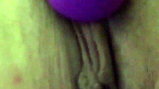 She uses a vibrator on her dry pussy lips during masturbation