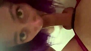 the purple haired girl performs a blowjob on the cock