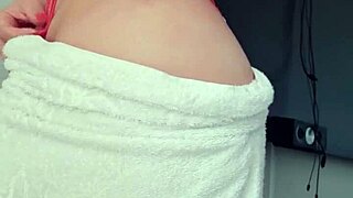 Latina blonde slut flaunts her big ass in a towel at the window 😍