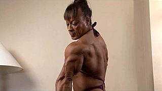 tall muscular bodybuilder women flex biceps in femdom session