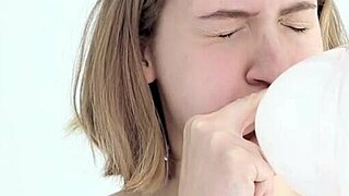 watch this young babe blow and pop her first balloon while giving a blowjob